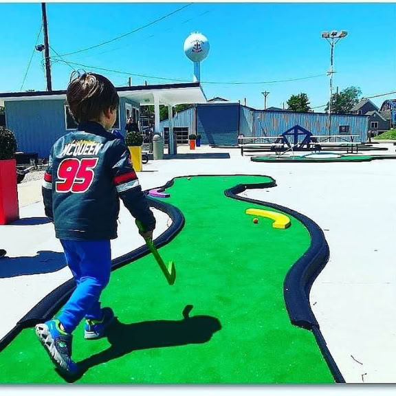 A kid putting at Romps Putter Port